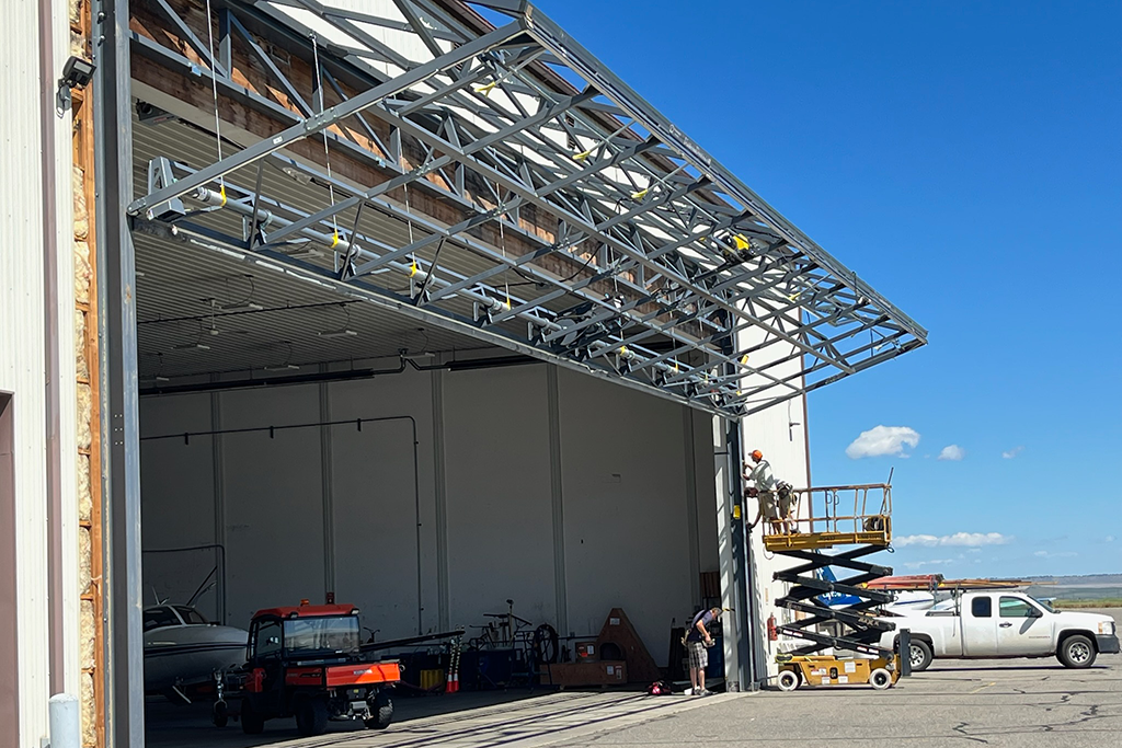 attaching commercial hangar door to building