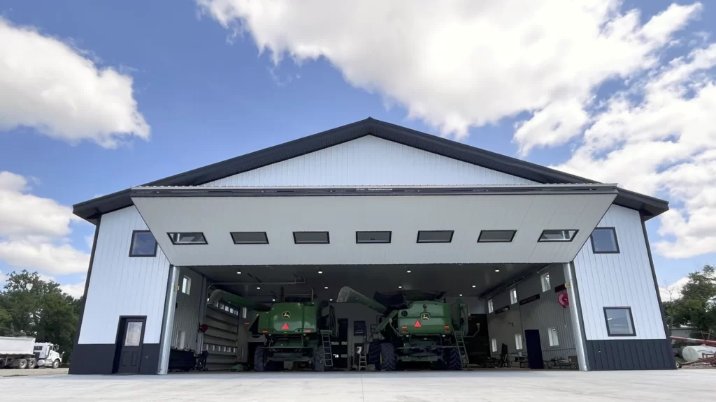 White Shed with Diamond Bifold door and two John Deere combines